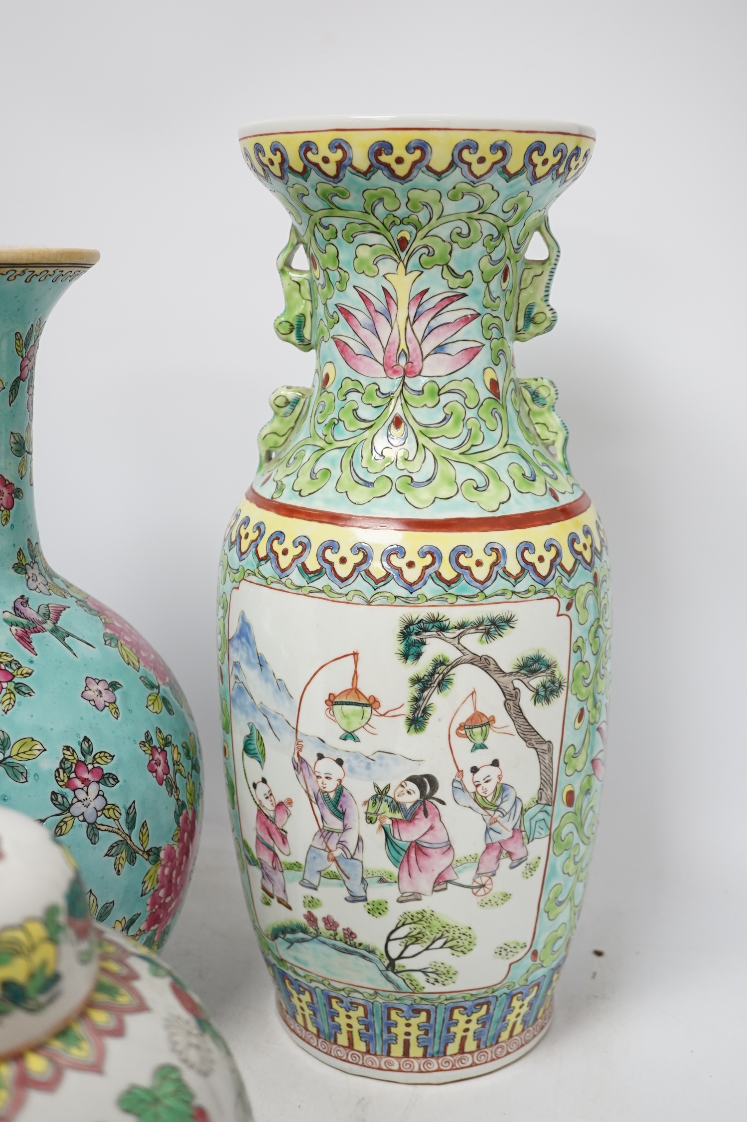 Two 20th century Chinese famille rose vases and a similar jar and cover, tallest 40cm. Condition - good